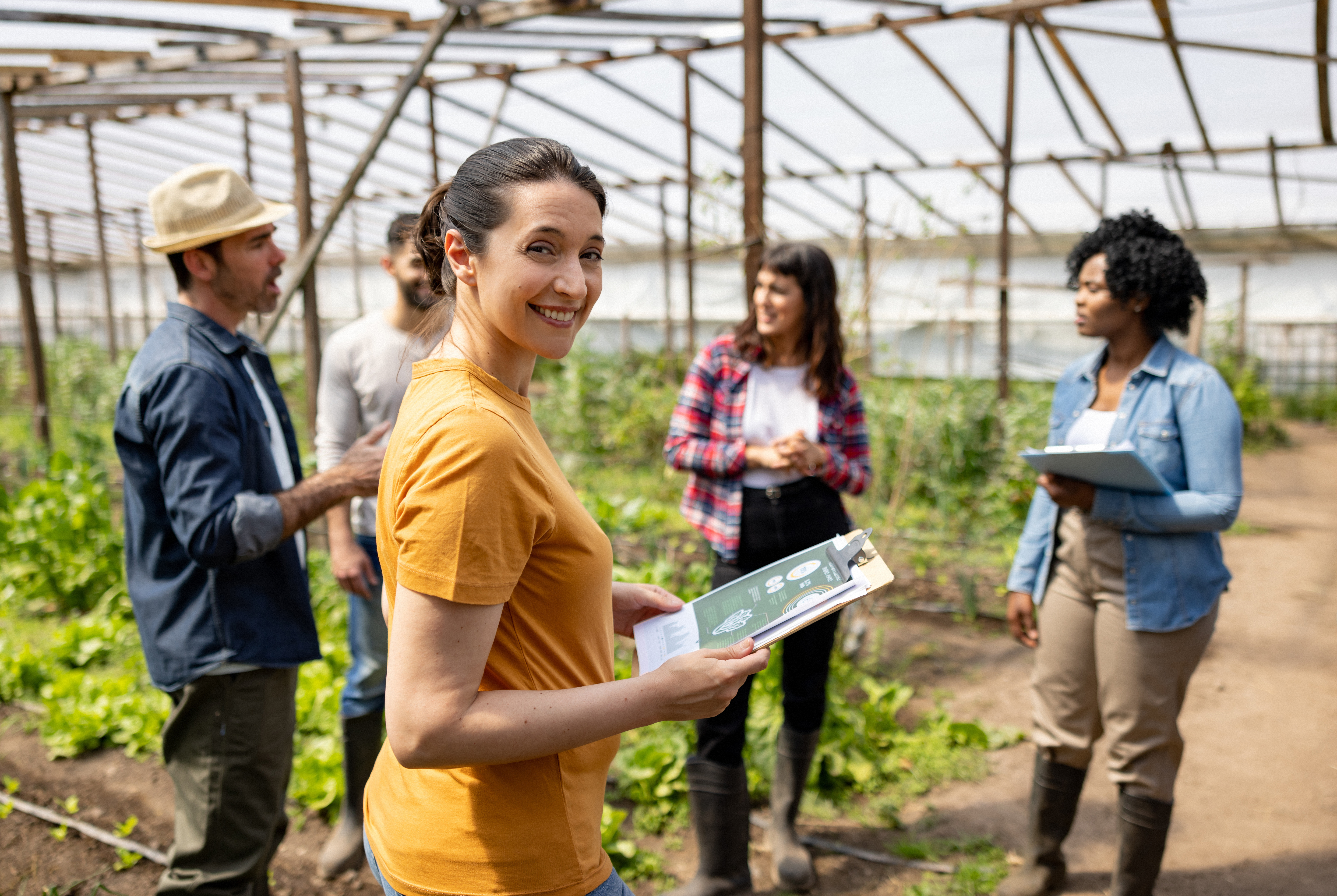 Latin American woman learning about organic farming at a community garden - sustainable lifestyle concepts